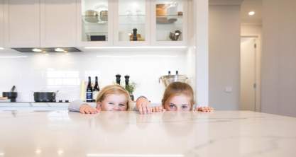 Kids playing in St Tropez Kitchen by  Wilson Homes